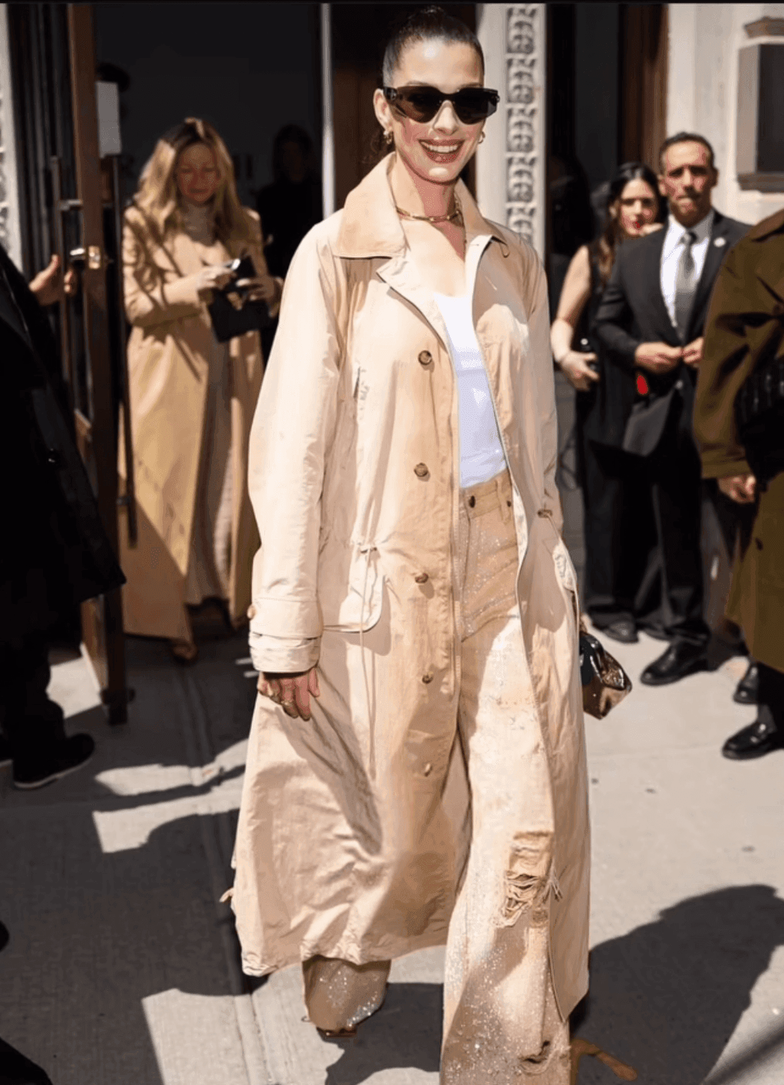 Anne Hathaway Wears Khaki Trench and Sequined Jeans to Ralph Lauren FW25 Show